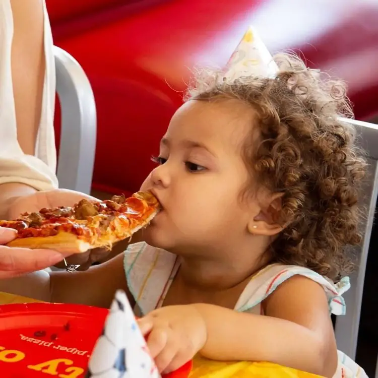 Little Girl Eating Pizza