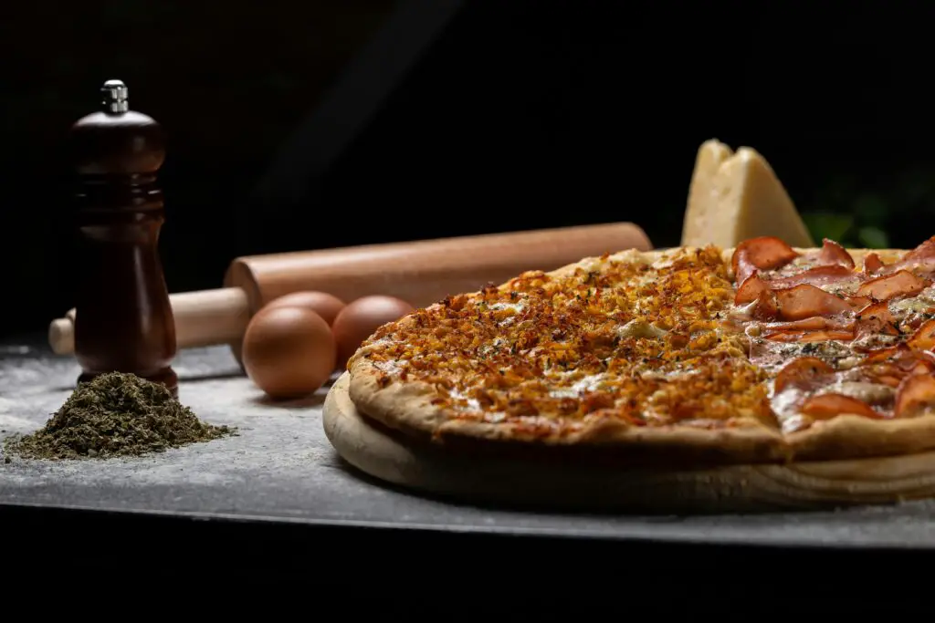 late night pizza, spicy, placed on table along with other kitchen appliances