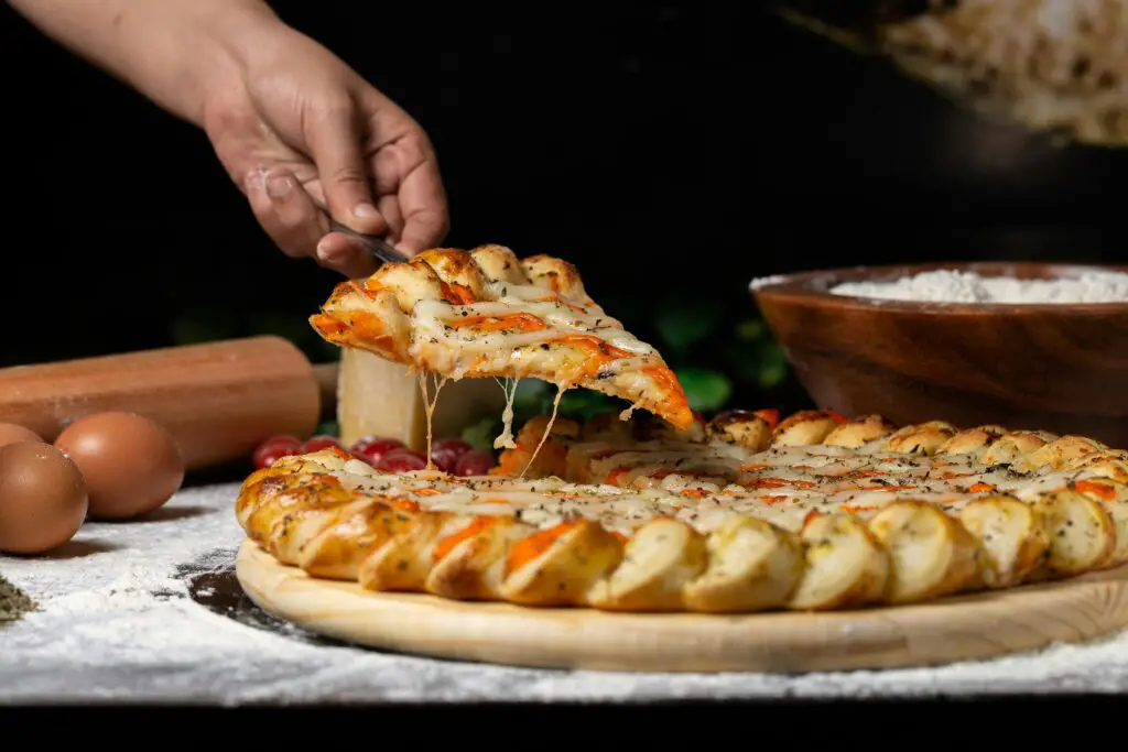 could semolina flour make pizza dough softer and chewy? A man picking pizza slice