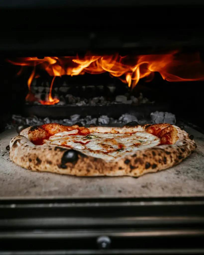 6 Reasons You Should Invest in Wood Fire Ovens.. Baking pizza on wood fire owen