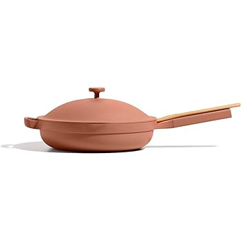 Modern terracotta-colored non-stick pan with lid and wooden handle - ideal for cooking pizza recipes and available on discounts at coupons.pizza.