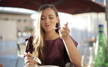 Teen with braces enjoying a slice of soft-crust pizza safely.